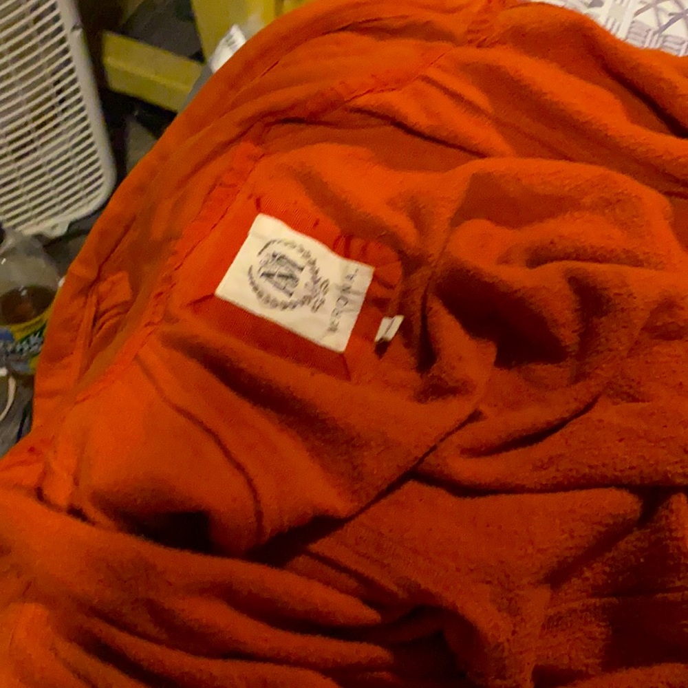 Orange sweater has deep side pockets worn one time